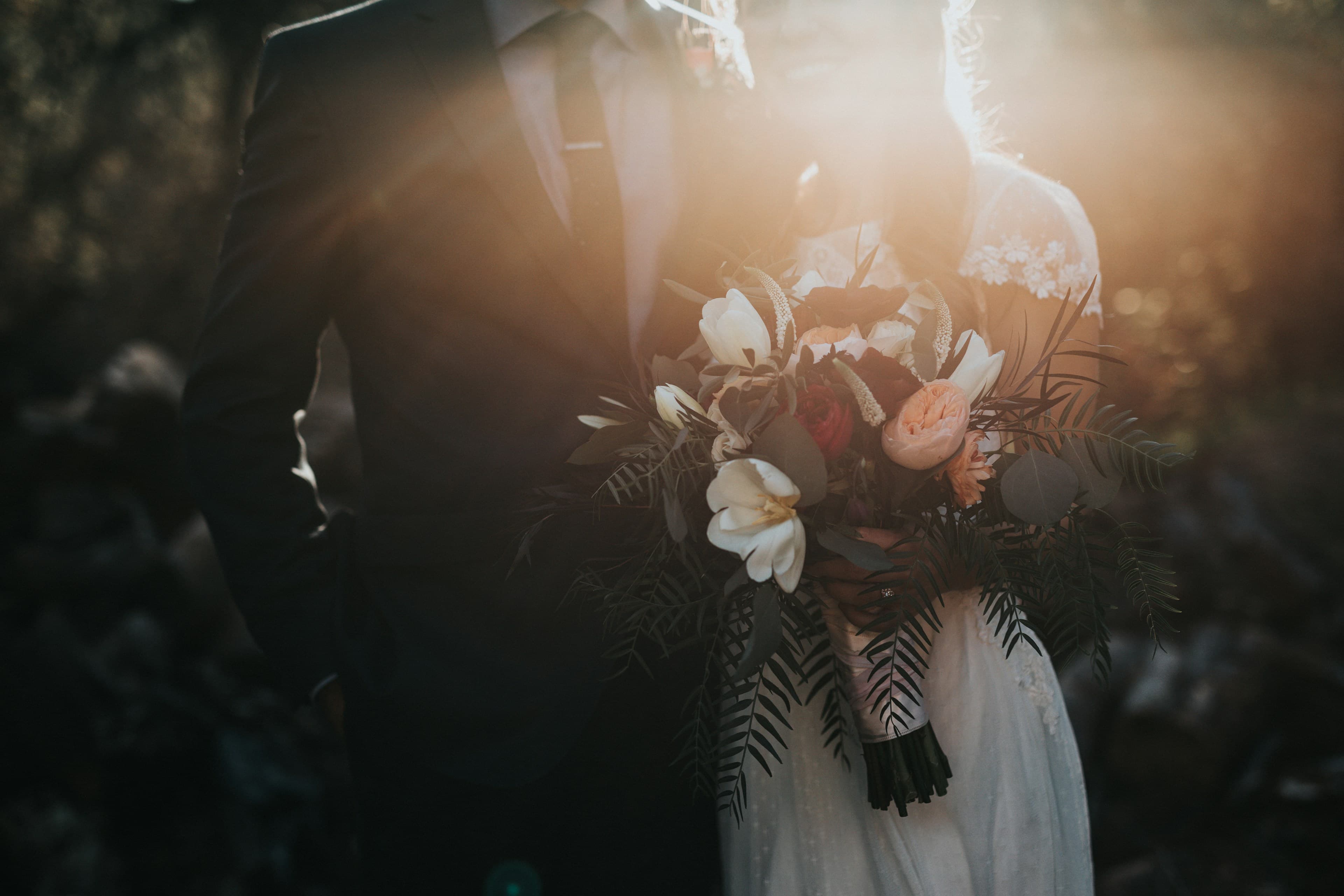 A couple celebrating with a bouquet