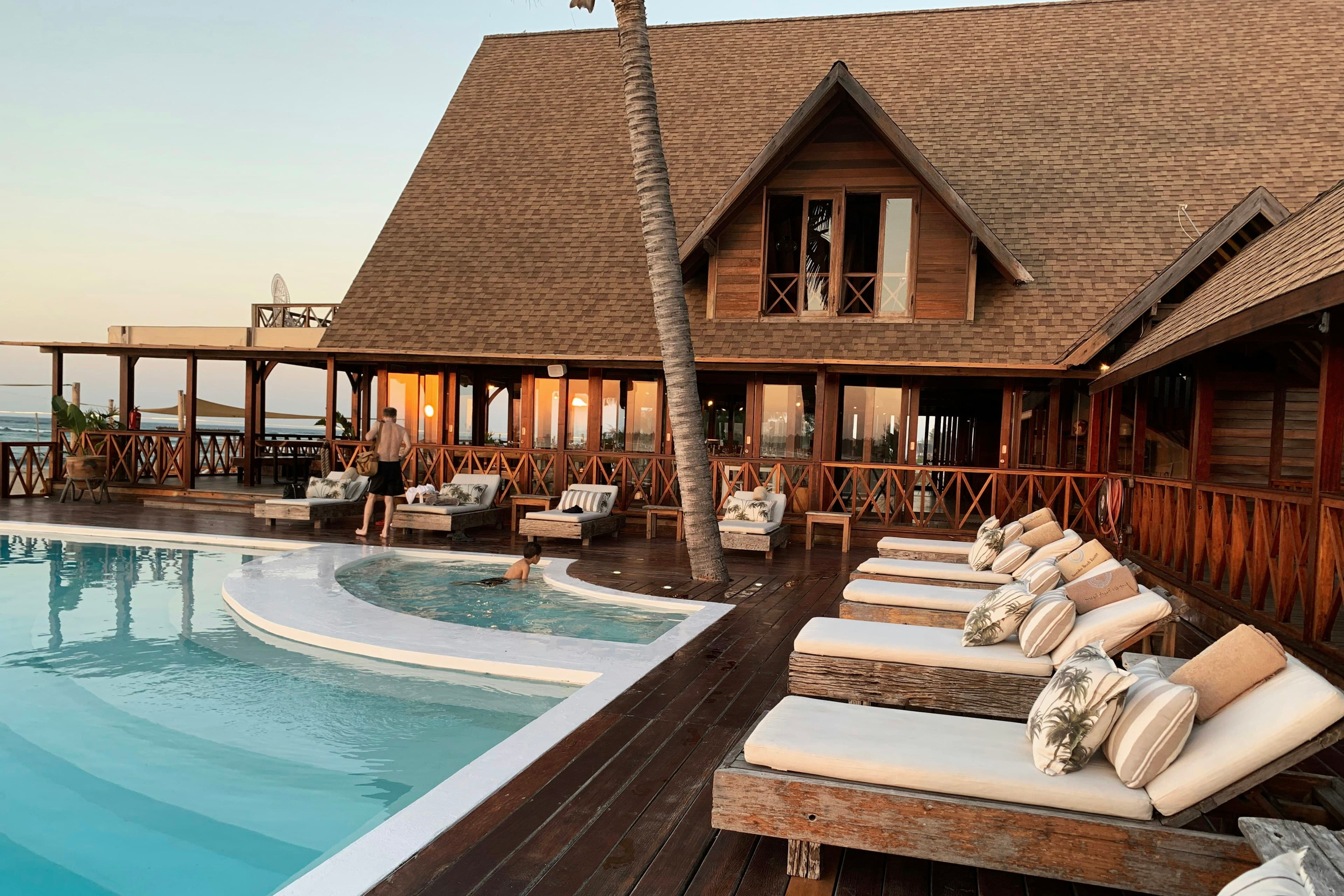A timber resort building beside a pool