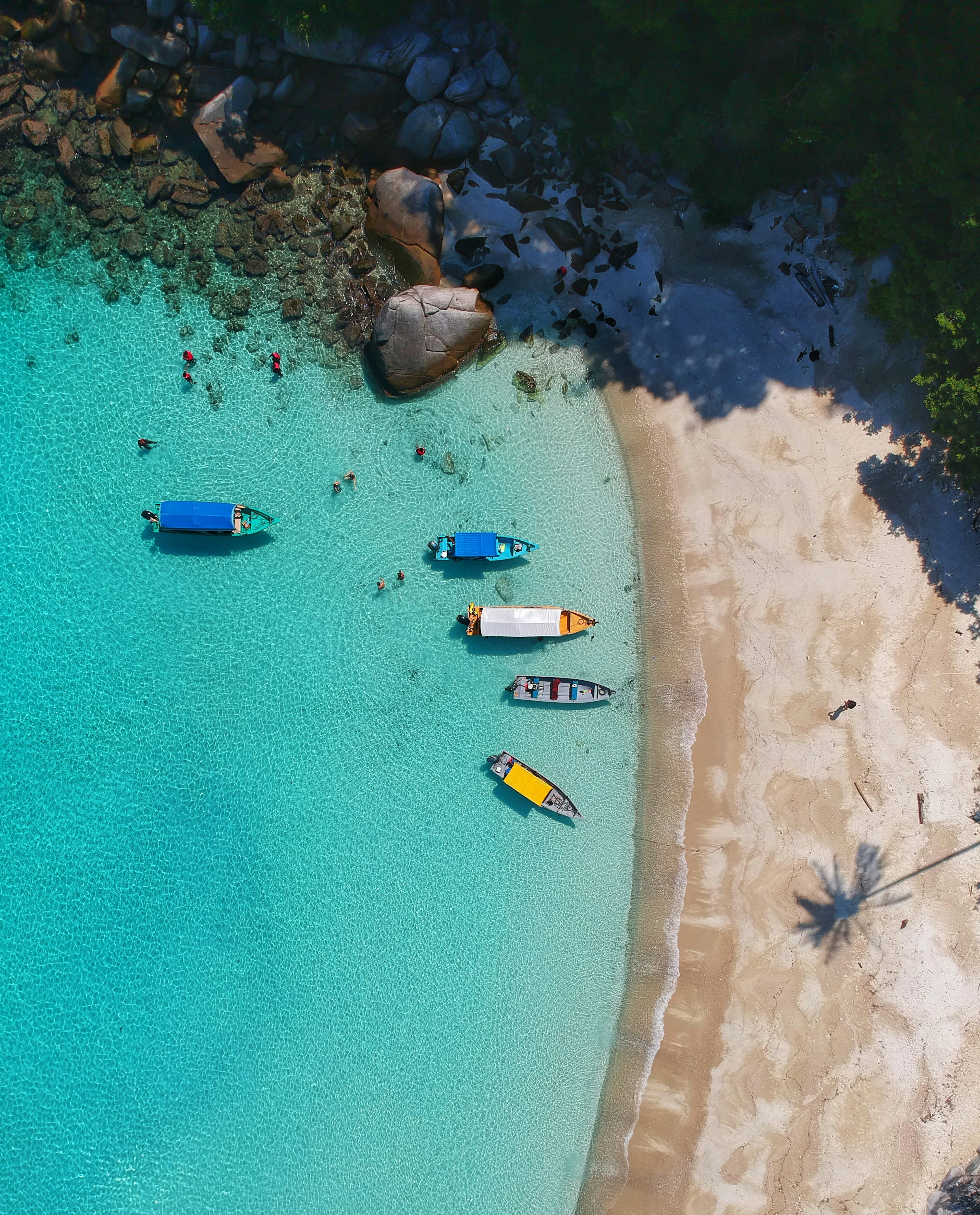 Aerial view of a beach with boats offshore