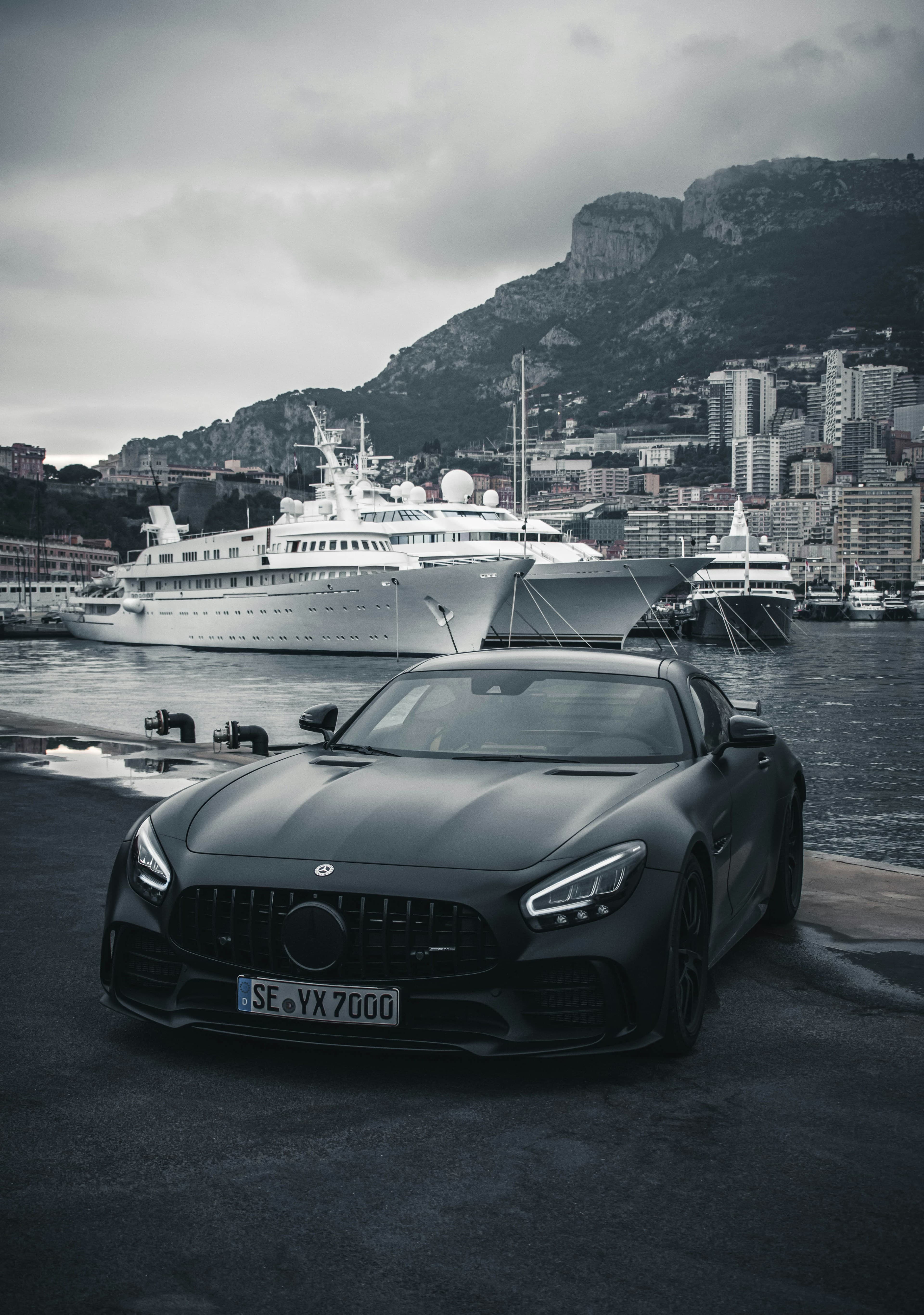 A sports car beside a yacht harbour