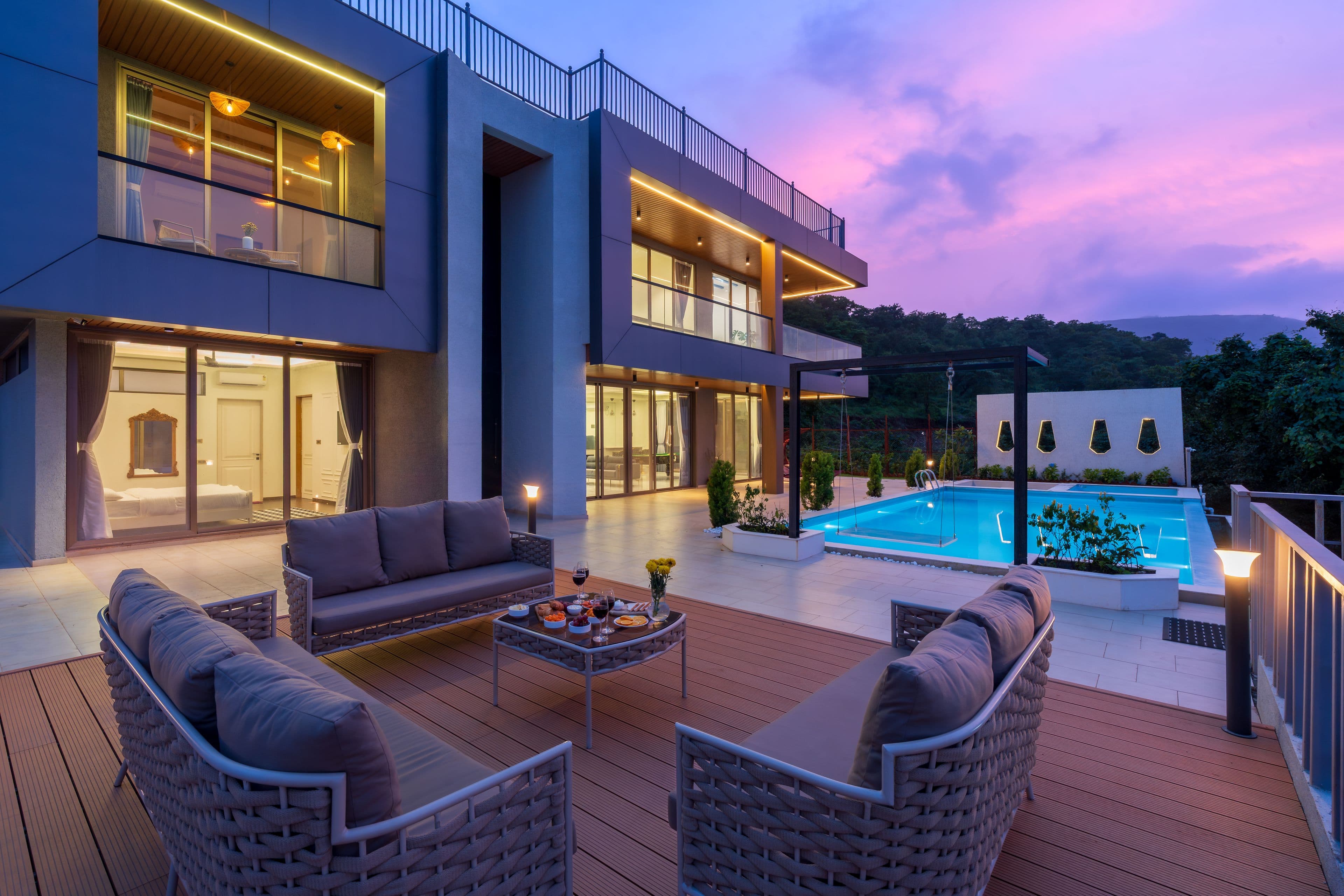 A warmly lit private villa at sunset